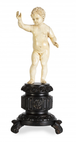 688.  Niño Jesús triunfante.Figura de marfil tallado, sobre peana de madera.Trabajo indo-portugués, Goa, S. XVII.