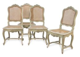 1029.  Juego de cuatro sillas Luis XV "a la reina" de madera tallada y lacada de verde con asiento y respaldo de rejilla.Francia, h. 1740.