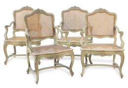 1030.  Juego de seis sillas de brazos "a la reina" de madera tallada y lacada de verde con asiento y respaldo de rejilla.Francia, h. 1740.