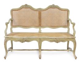 1032.  Canapé de madera tallada y lacada de verde con asiento y respaldo de rejilla.Francia, h. 1740.