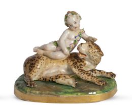 1279.  Niño con leopardo.Figura de porcelana esmaltada.S. XIX.