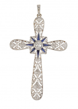 128.  Cruz colgante Art-Decó de zafiros y diamantes, con un brillante en chatón central; en brazos con decoración calada