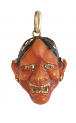 107.  Colgante de coral y esmalte con diseño de máscara tallada decorada con restos de esmalte