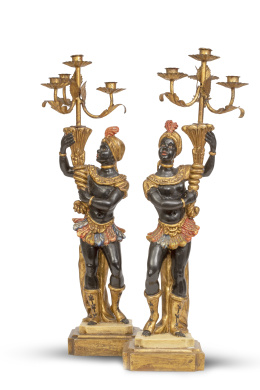 1271.  Pareja de "Blackamoors" de madera tallada, policromada y dorada, sustentando un candelabro de cuatro brazos de luz de metal dorado.Trabajo veneciano, primera mitad del S. XX.