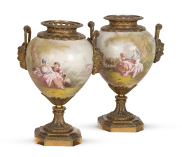 1111.  Pareja de jarrones de esstilo Luis XVI ,de porcelana esmaltada y montados en bronce dorado, con escenas pastorales firmadas por Dapoigny.Francia, h. 1900.