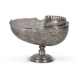 1304.  Naveta barroca de plata en su color con decoración grabadade hojas carnosas y leyenda:  "El Licenciado Don Antonio Garzia de Zilla".Guatemala, h. 1700.