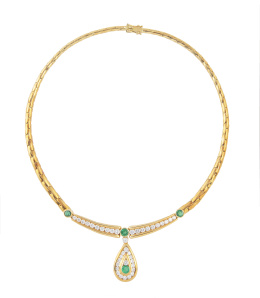 181.  Collar de brillantes y esmeraldas, con centro compuesto por dos bandas arqueadas de brillantes en carril entre esmeraldas ovales con gota colgante de esmeralda central y contorno de brillantes engastados en carril
