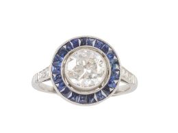 359.  Sortija solitario ojo de perdiz con un brillante central de 1,36 ct aprox orlado de zafiros calibrados en talla francesa