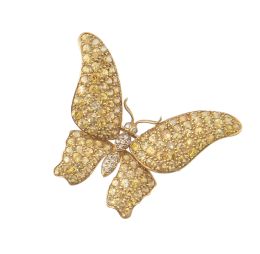 238.  Broche mariposa con alas cuajadas de zafiros amarillos y cuerpo de brillantes