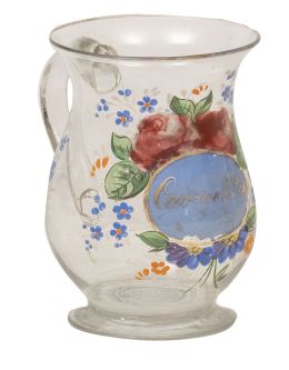 752.  Jarrita de vidrio transparente con flores pintadas y nombre "Carmelita" dorado en cartela con fondo azul.La Granja, S. XIX.