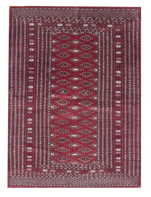 Alfombra en lana de campo rojo con motivos geométricos.