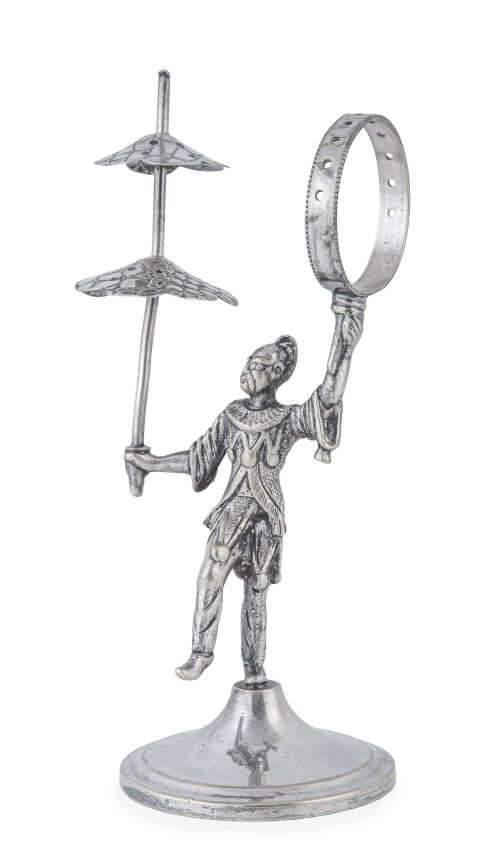 Palillero de metal plateado con figura circense. Con marcas