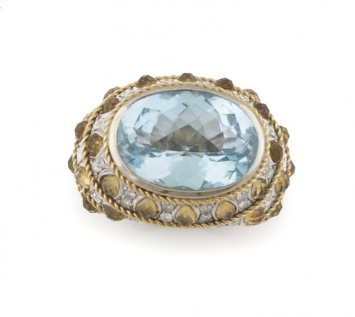 Sortija con topacio azul oval facetado e montura elevada co