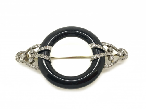 Broche circular Art-Decó con aro de ónix abrazado por motiv