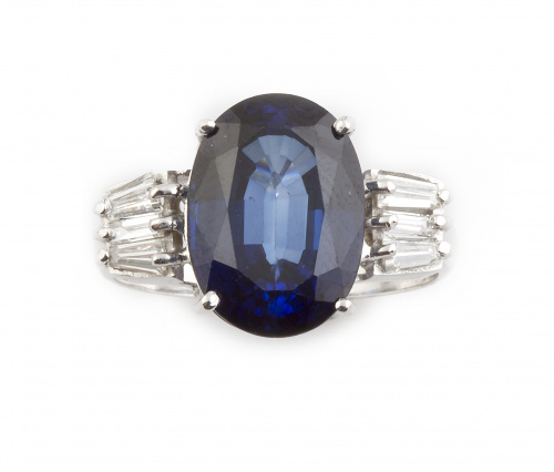 Sortija con zafiro oval de 7 ct flanqueado por tríos de dia