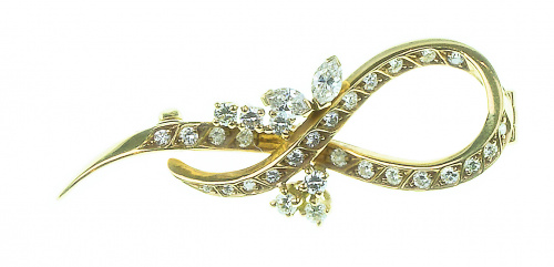 Broche lazo de brillantes en oro amarillo de 19K con flores