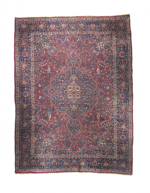 Alfombra en lana con campo rojo, con cartucho central y med