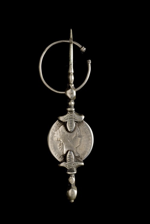 Lote formado por doce fíbulas con monedas 