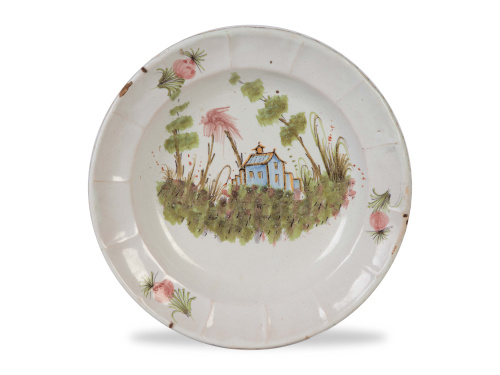 Plato acuencado de cerámica esmaltada con una arquitectura 