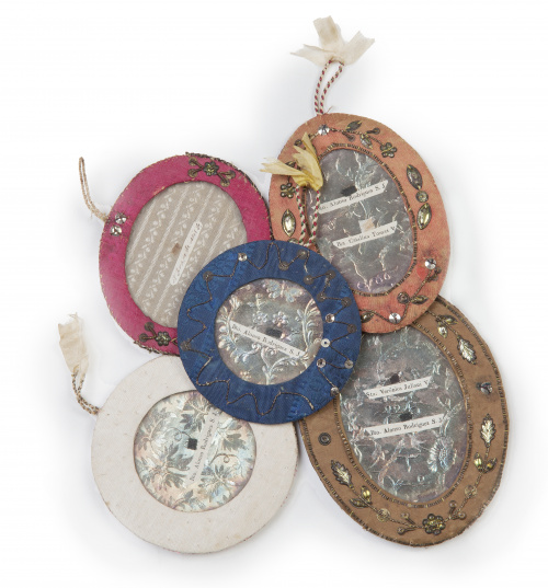 Lote de cinco relicarios en marcos de tela y aplicación de 