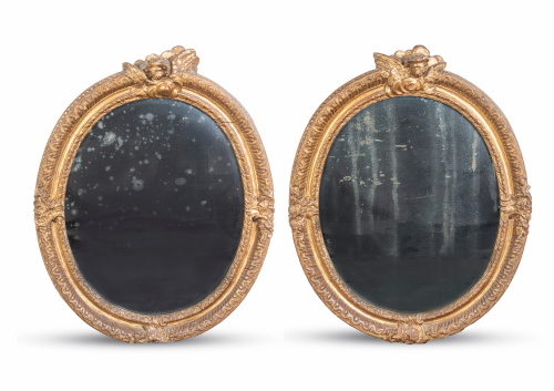 Pareja de espejos ovales regencia en madera tallada y dorad