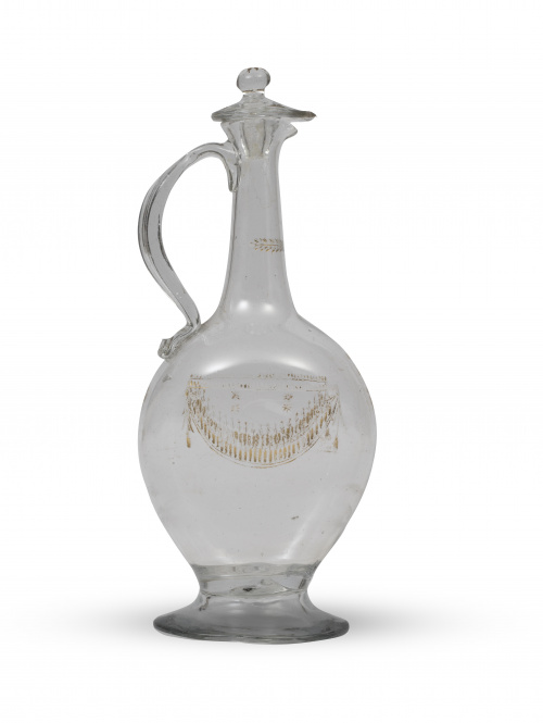 Garrafa de vidrio con asa con cristal dorado y grabado.La