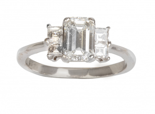 Sortija con diamante central talla esmeralda flanqueado por