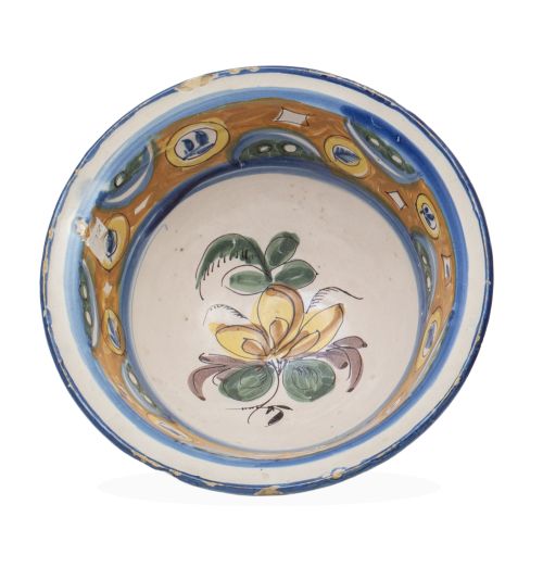 Cuenco de cerámica esmaltada con ramillete en el asiento.