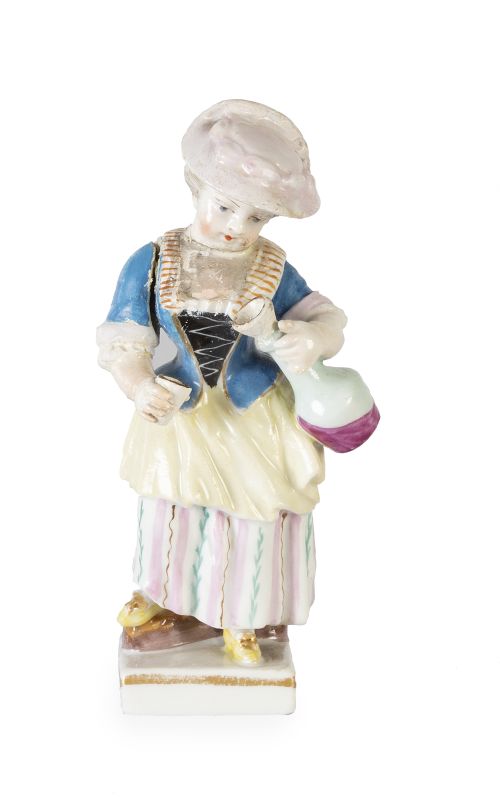 Niña con jarrito.Figura de porcelana esmaltada y dorada. 