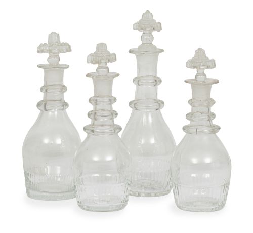 Juego de cuatro licoreras de vidrio transparente.S. XIX.