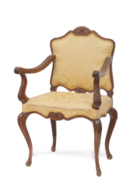 Silla de brazos de madera tallada, fechada en el reverso "1