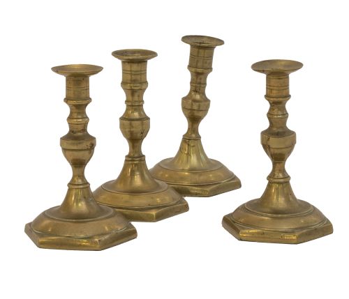 Lote de cuatro candeleros de bronce dorado.España, S. XIX.